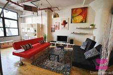 modern living room with 2 queensize sleeper sofas and large window